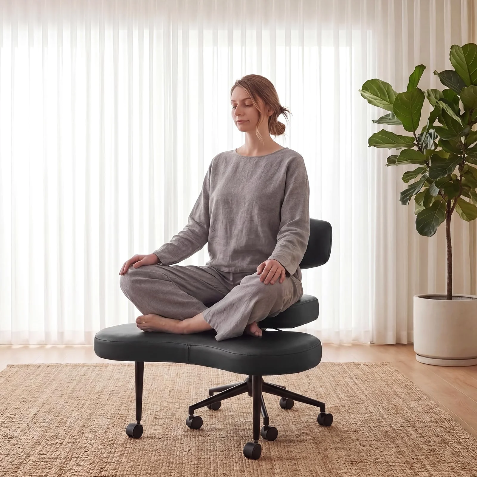 A wide armless DUMOS chair with a person sitting cross-legged on it